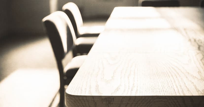 An empty boardroom table a few minutes after a meeting has ended